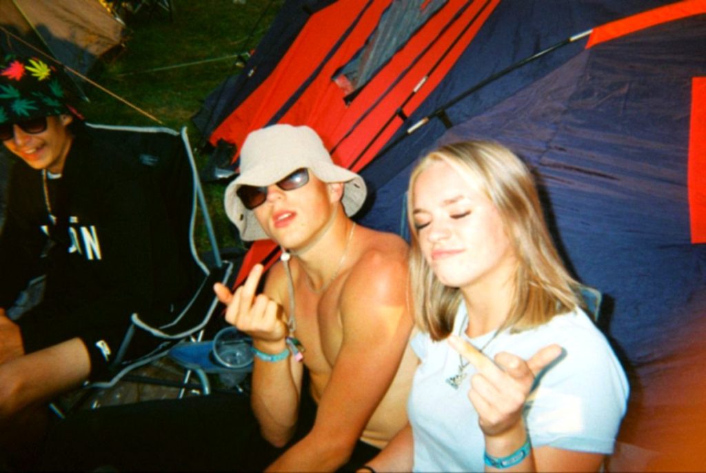 Two friends wearing sunglasses and caps at the campground
