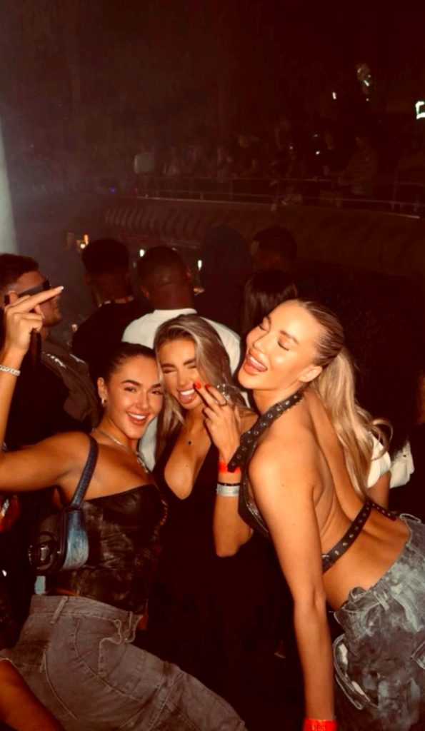 Three friends in the dark at a festival, a candid photo